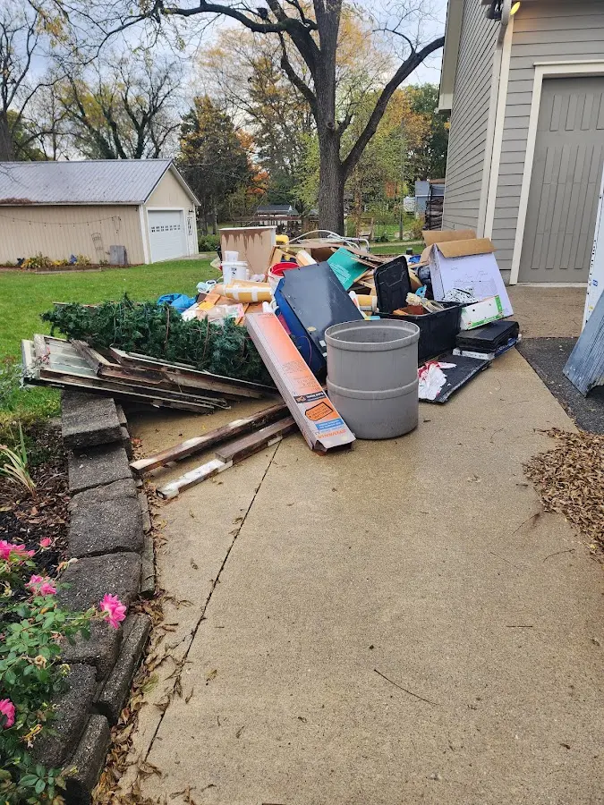 Dumpster being loaded with debris for 12 Yard Dumpster Rental in Blue Ash